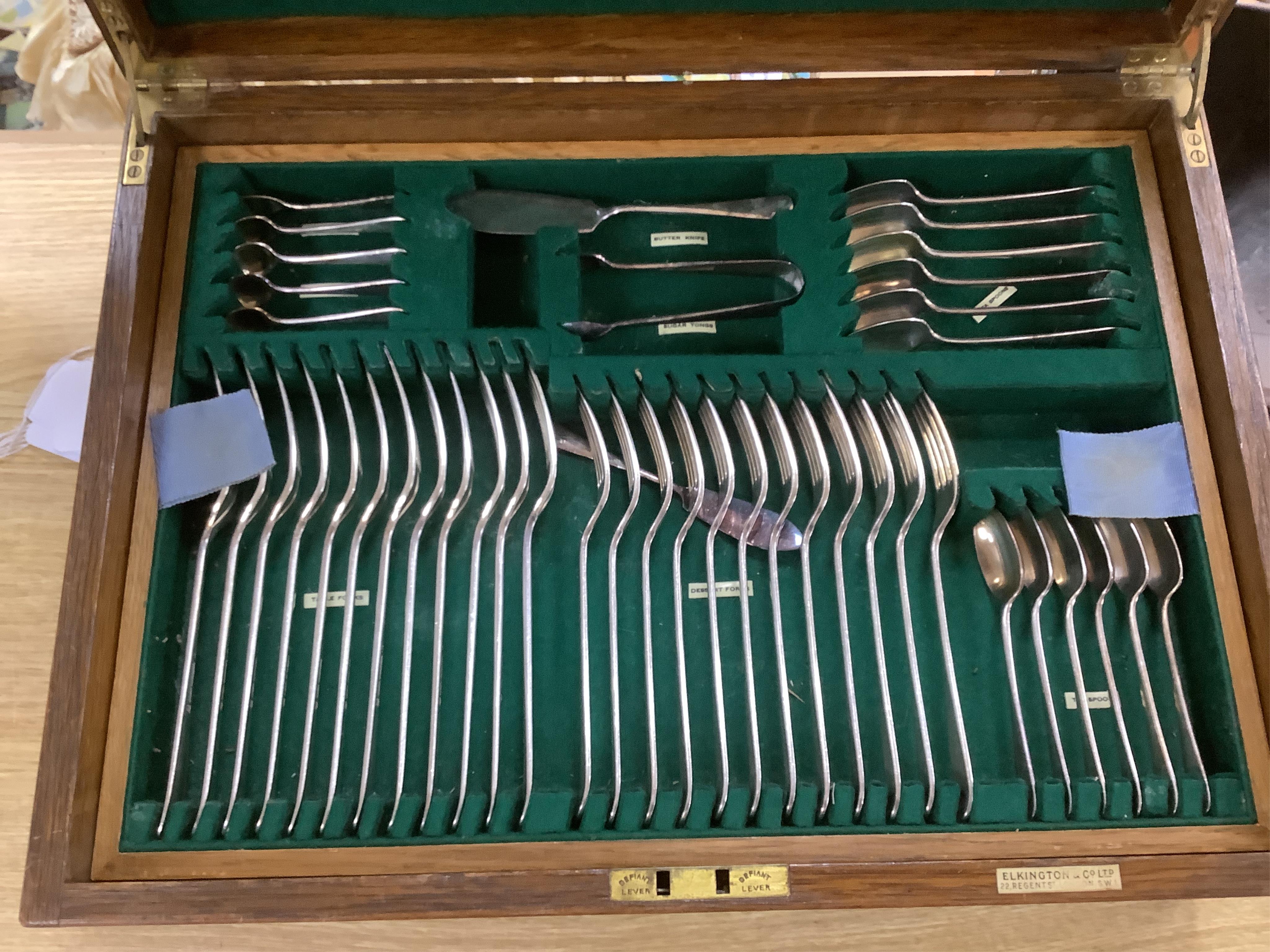 An Elkington & Co plated Old English pattern canteen of cutlery, oak cased, 48cm wide. Condition - fair